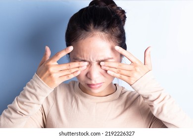Close-up of young woman rubbing irritated eyes, eye irritation, eye rubbing, eye problems, migraine pain - Shutterstock ID 2192226327