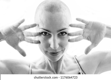 Close-up Of Young Woman With Shaved Head Smiling In Black And White