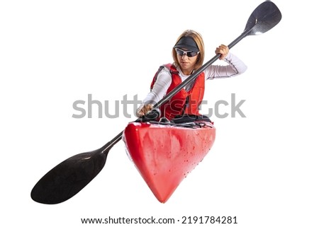 Closeup. Young woman, sportsman in red canoe, kayak with a life vest and a paddle isolated on white background. Concept of sport, nature, travel, active lifestyle