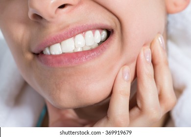 Closeup of young woman suffering from toothache at home