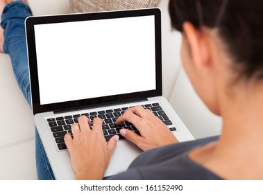 Close-up Of Young Woman Using Laptop On Couch - Powered by Shutterstock