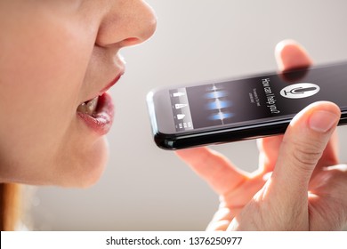 Close-up Of A Young Woman Using Voice Recognition Function On Mobile Phone - Powered by Shutterstock