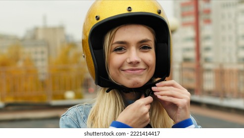 Close-up of Young Woman Wears Open Face Golden Motorcycle Helmet Before Riding a Bike - Shutterstock ID 2221414417