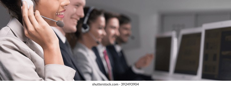 Close-up Of Young Woman Working In Call Center Company As A Telemarketer