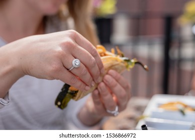 Closeup Of A Young Womans Hand With Diamond Engagement Ring Eating Tacos In Summer