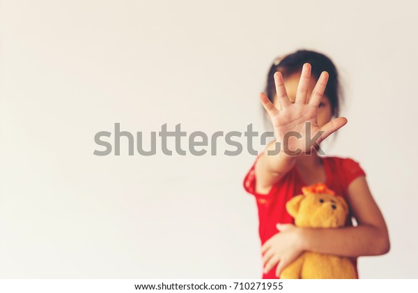 Close-up of young\
woman\'s hand, stop\
sign