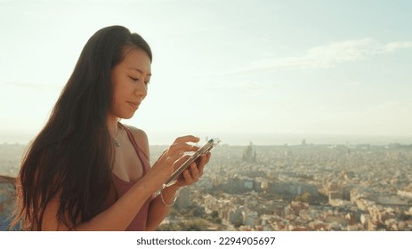 Close-up of young woman's hands using mobile phone