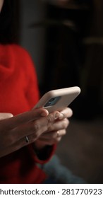 Close-up of a young woman's hands using a smartphone at home, highlighting mobile technology, digital communication and everyday connected lifestyle.