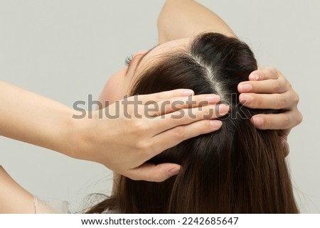 Close-up of a young woman's scalp .