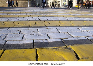 Close-up of a zebra (pedestrian) crossing on paved with gray granite Vasilevsky descent. Vasilevsky descent territory extends from the Red Square to the Kremlin embankment. 