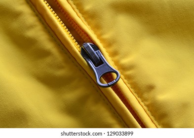 Closeup Of Zipper On Yellow Coat With Texture