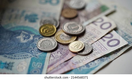 Close-up of zloty banknotes and coins on a white background, Polish currency. The concept of currency exchange in another country. Selective focus - Shutterstock ID 2144568371