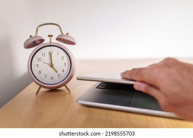 Closing the laptop at 5 p.m. Quiet quitting concept - Shutterstock ID 2198555703
