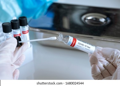 Closing a sample testing for presence of coronavirus. Tube containing a swab test for COVID-19.