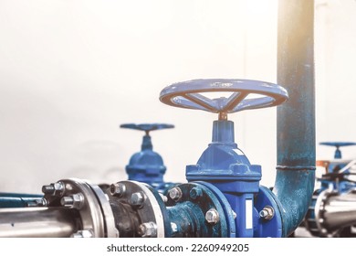 Closing valve on water pump station is pipeline with tanks in an technical room for supply of high-pressure aqua. Water sprinkler pipes and pressure control industrial system. Copy text space