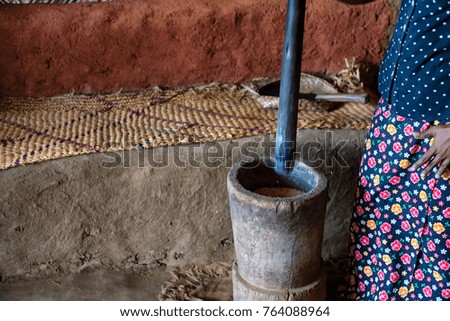 Closseup Indian woman works with mortar and pestle