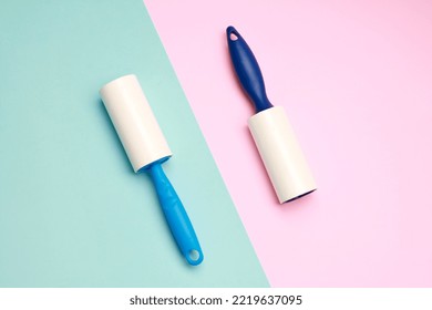 Cloth fabrics cleaner lint roller brush with paper roll blue grip on pink mint green color background. sticky roller, pet cat dog fur dust hair remover. Top view. Flat lay - Powered by Shutterstock