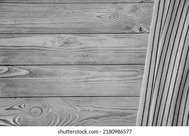 Cloth Napkin On The Background Of A Table From A Rustic Wooden Board, Top View, Mockup For Design.