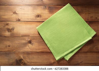 cloth napkin on wooden background - Shutterstock ID 627283388
