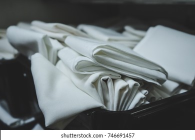 Cloth Table Linens Folded And Placed In Bin, Ready To Be Set Out In The Restaurant Dining Room For Guests To Use.