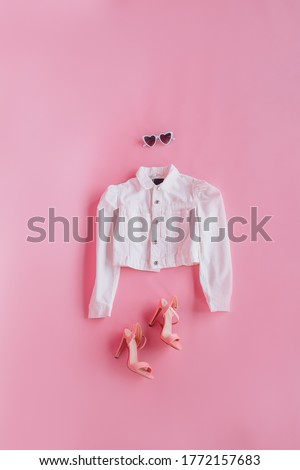 Clothes for doll. jacket, sunglasses, and pink shoes on a pink background. Barbie style