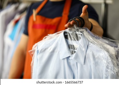 Clothes Dry Cleaning Service Worker Returning Shirts To Customer Close-up