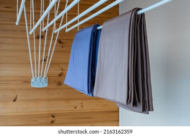 clothes dryer attached to the ceiling with clothes hanging. High quality photo