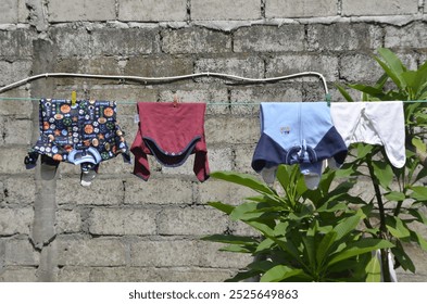 Clothes Drying on a Line Against a Brick Wall - Powered by Shutterstock