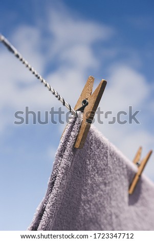 
Clothes drying outdoors. Close-up wooden clothespin. Clothes hanging rope.