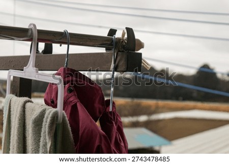 Clothes drying outside under rain with visible raindrops and overcast sky