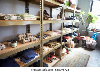 Clothes And Ephemera Displayed On Shelves In A Clothing Shop