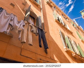 Clothes hang drying in Venice, Italy above the canal - Powered by Shutterstock