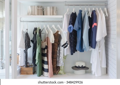 Clothes Hanging In Closet With Hat At Home