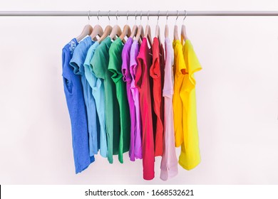 Clothes Hanging On Clothing Rack Wardrobe Fashion Apparel Selection Of Rainbow Color T-shirts On Closet Hangers. Womens Wear In Store Shopping Spring Cleaning Concept. Summer Home Wardrobe.