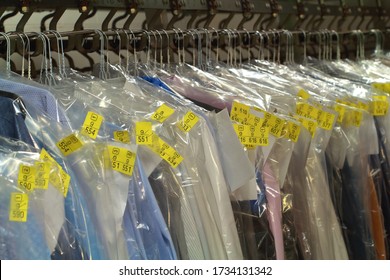 Clothes Hanging On The Conveyor Belt Of The Dry Cleaner