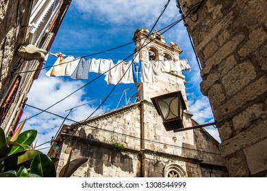 Clothes Hanging On Laundry Line Between Two Buildings In Old Town Of Korcula