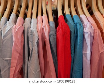 clothes hanging on a railing in a clothing store. - Shutterstock ID 1938199123