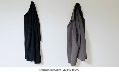Clothes hanging on the white wall - Shutterstock ID 2334039297