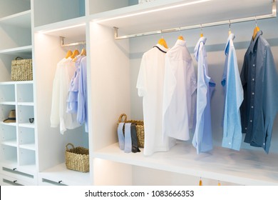 Clothes hanging in white wooden  wardrobe  - Powered by Shutterstock