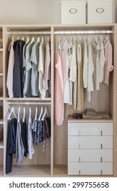 Clothes Hanging In Wooden Wardrobe At Home