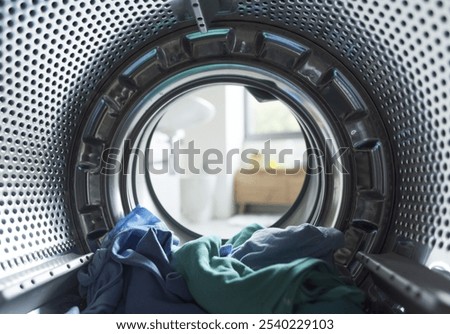 Clothes inside the washing machine, laundry and hygiene concept