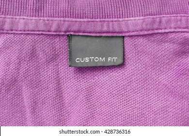 Clothes Label Lettered Custom Fit On Pink Cloth As A Background
