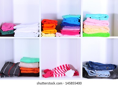 Clothes Neatly Folded On Shelves