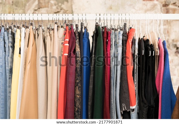 Clothes on hangers - second hand clothes store or\
thrift shop. Clothing rental service. Clothes rail with copy space\
for text. Selective\
focus