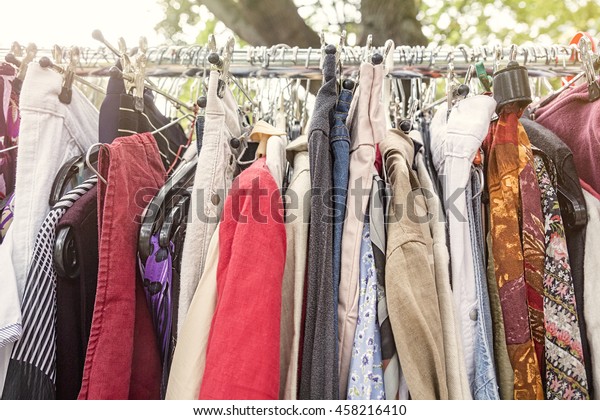 clothes on a rack on a flea\
market
