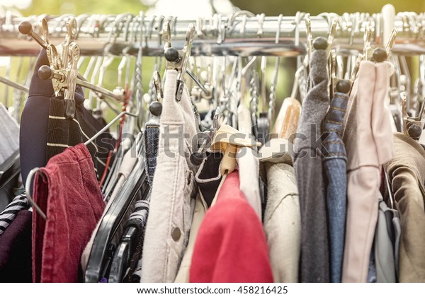 clothes on a rack on a flea\
market