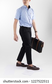 Clothes, People, Luxury, Background, Fashion, Style Concept -   Young Asian Men Carry Leather Black Businees Bag With Blue Oxford Shirt Short Sleeve And Black Slack Pants On White Background