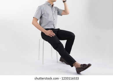 Clothes, People, Luxury, Background, Fashion, Style Concept -   Young Asian Men Sitting On White Chair With Gray Oxford Shirt Short Sleeve And Black Slack Pants On White Background