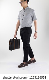 Clothes, People, Luxury, Background, Fashion, Style Concept -   Young Asian Men Carry Leather Black Businees Bag With Gray Oxford Shirt Short Sleeve And Black Slack Pants On White Background