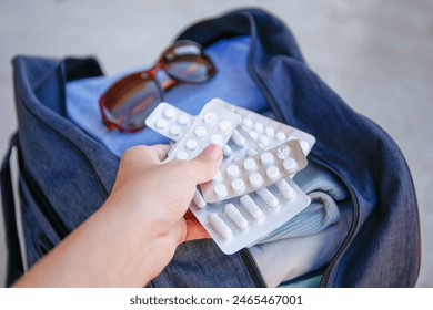 Clothes and pills in a travel bag. Concept of medication required in journey.
 - Powered by Shutterstock